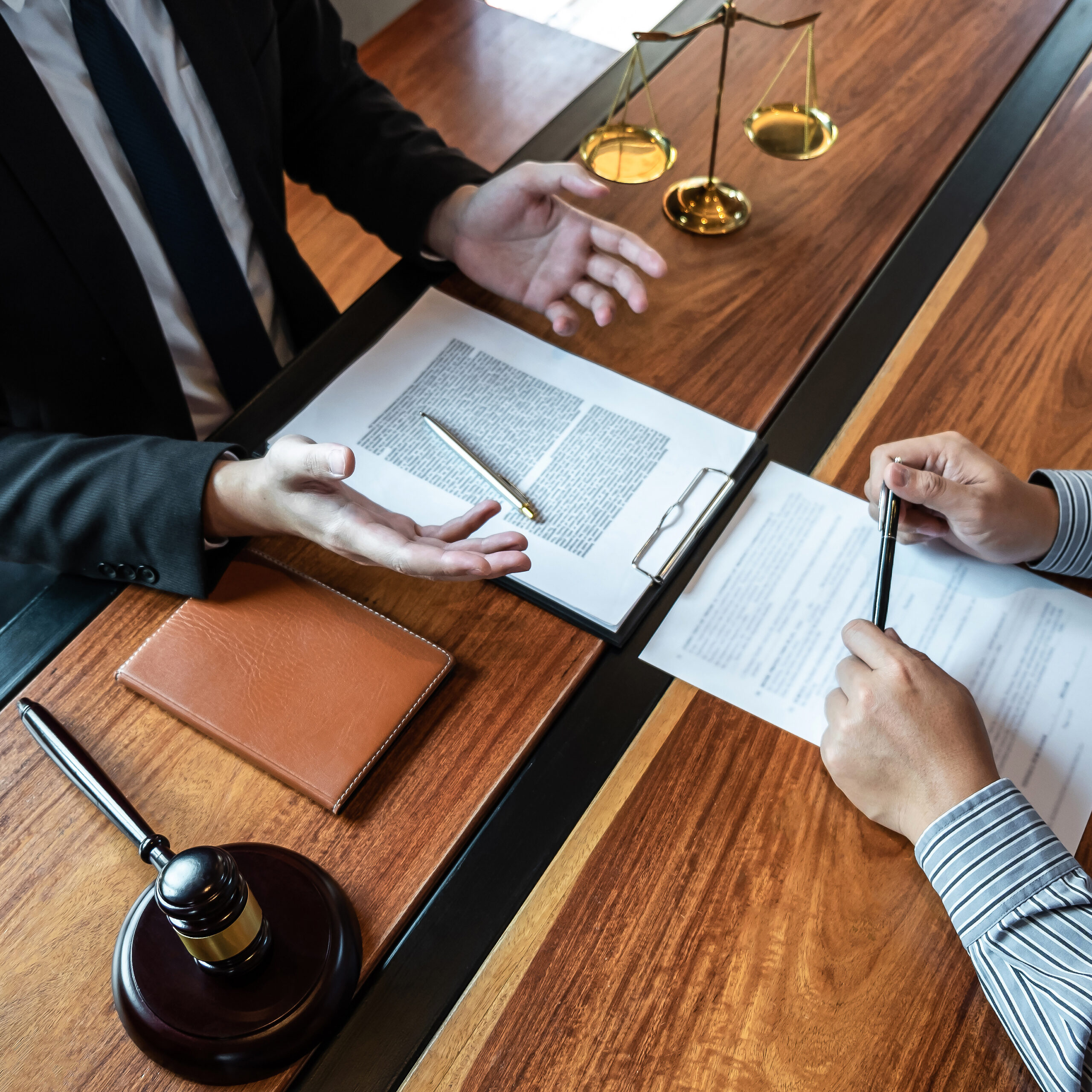 Professional male lawyer or counselor discussing negotiation legal case with client meeting with document contract in office, law and justice, attorney, lawsuit concept.